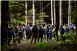 A group of people watching a demo in a forest