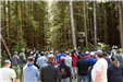 People listening to a speech in some woods