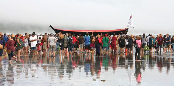 A group of people carrying a canoe