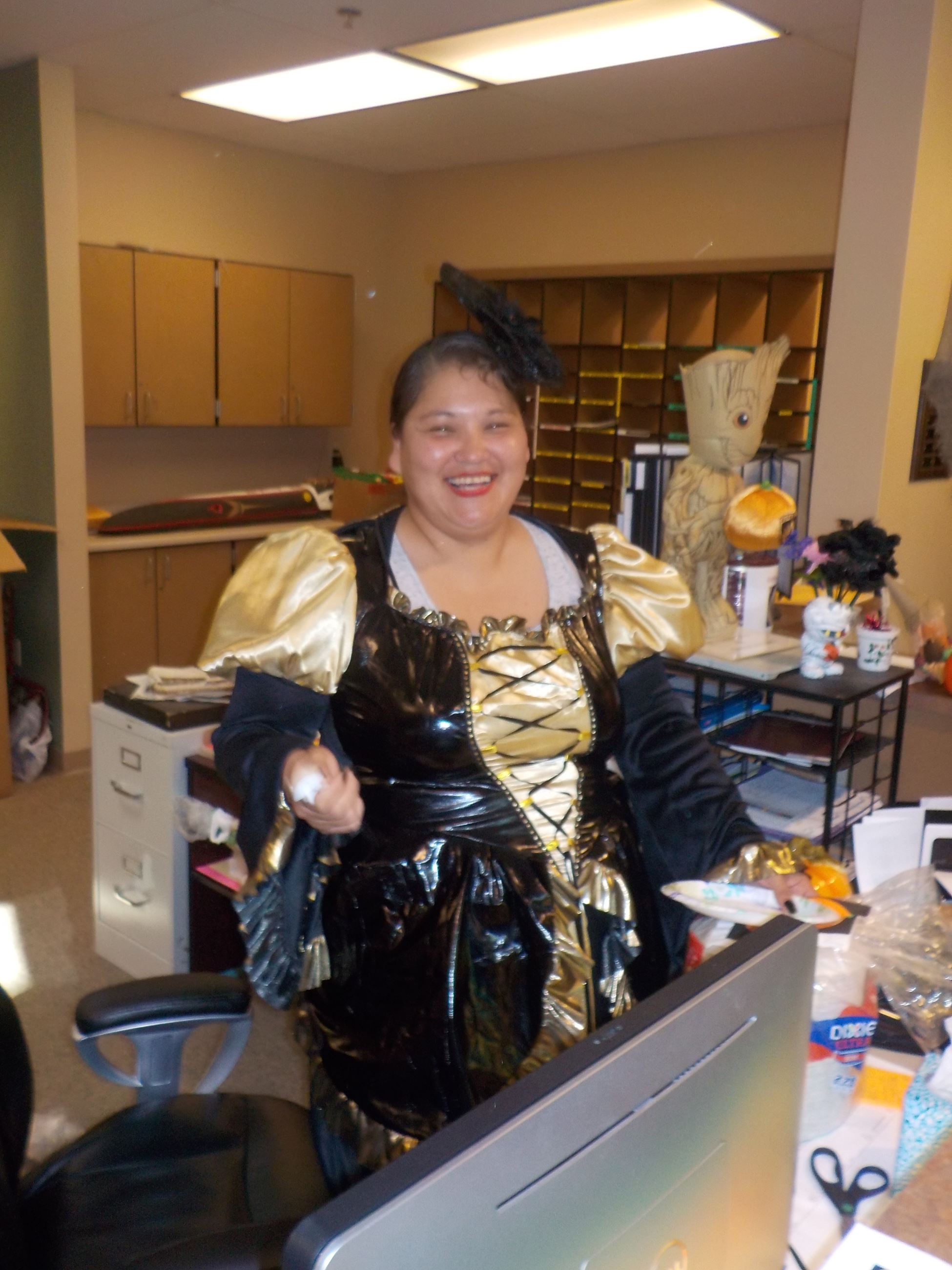 A woman in costume smiling at the camera