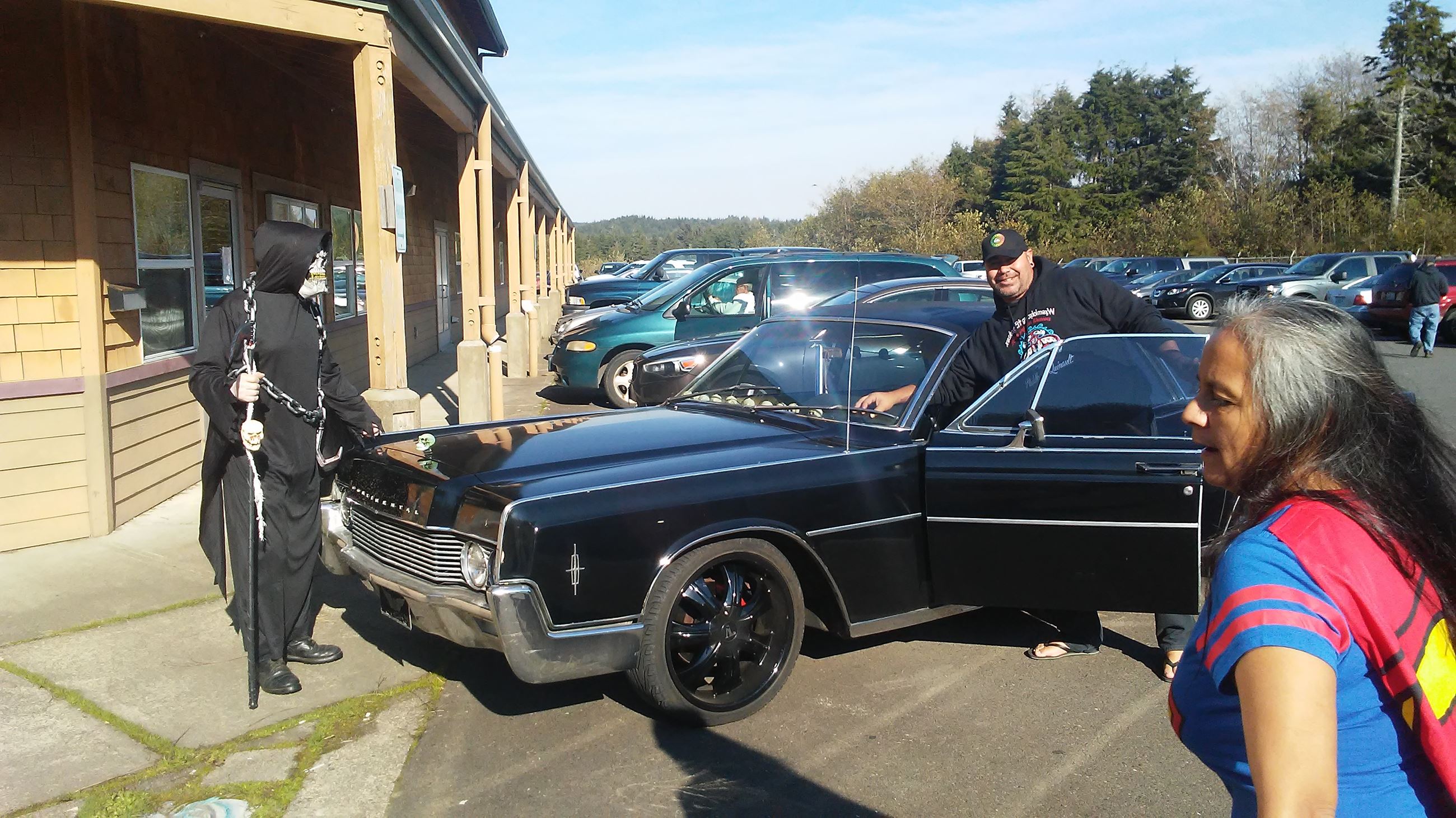 People standing around a classic car