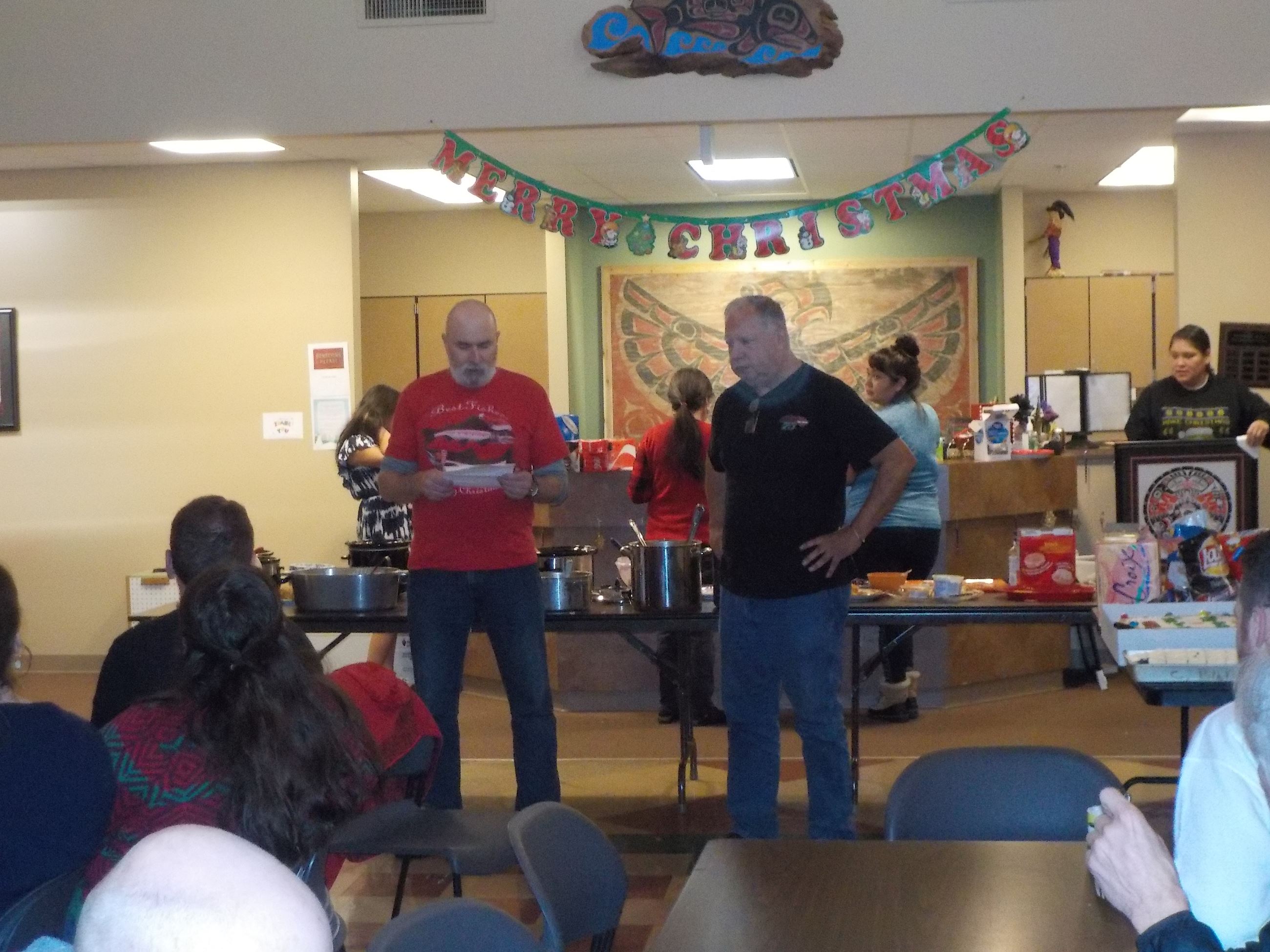 A man reads from a sheet of paper