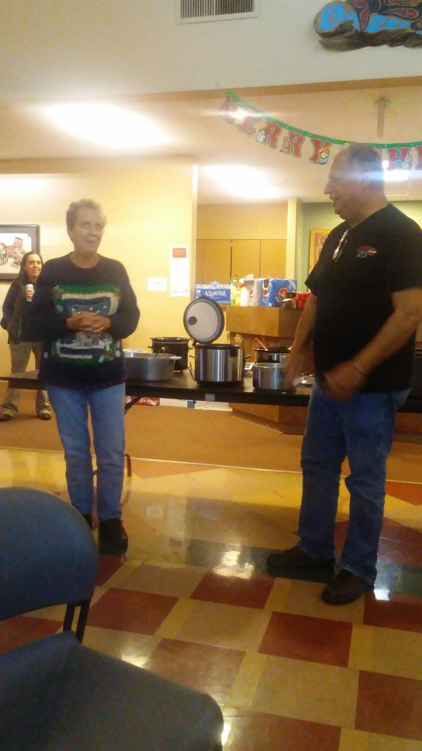 Two people standing in front of a food buffet