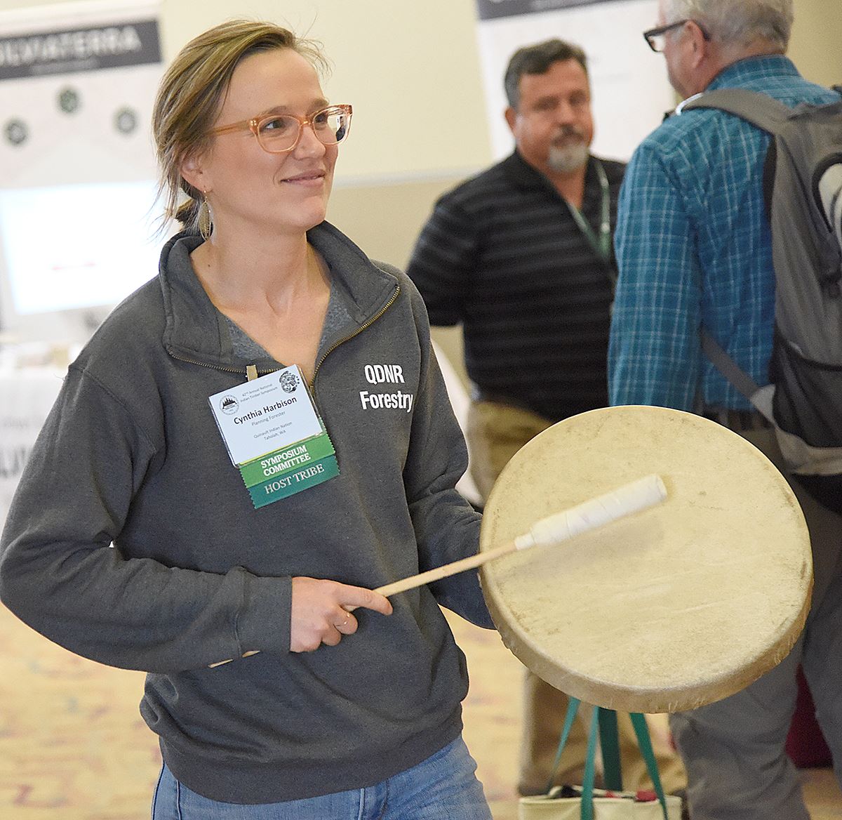 A woman beating a drum