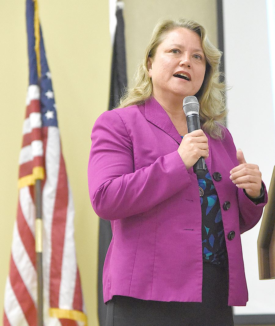 A woman speaks into a microphone