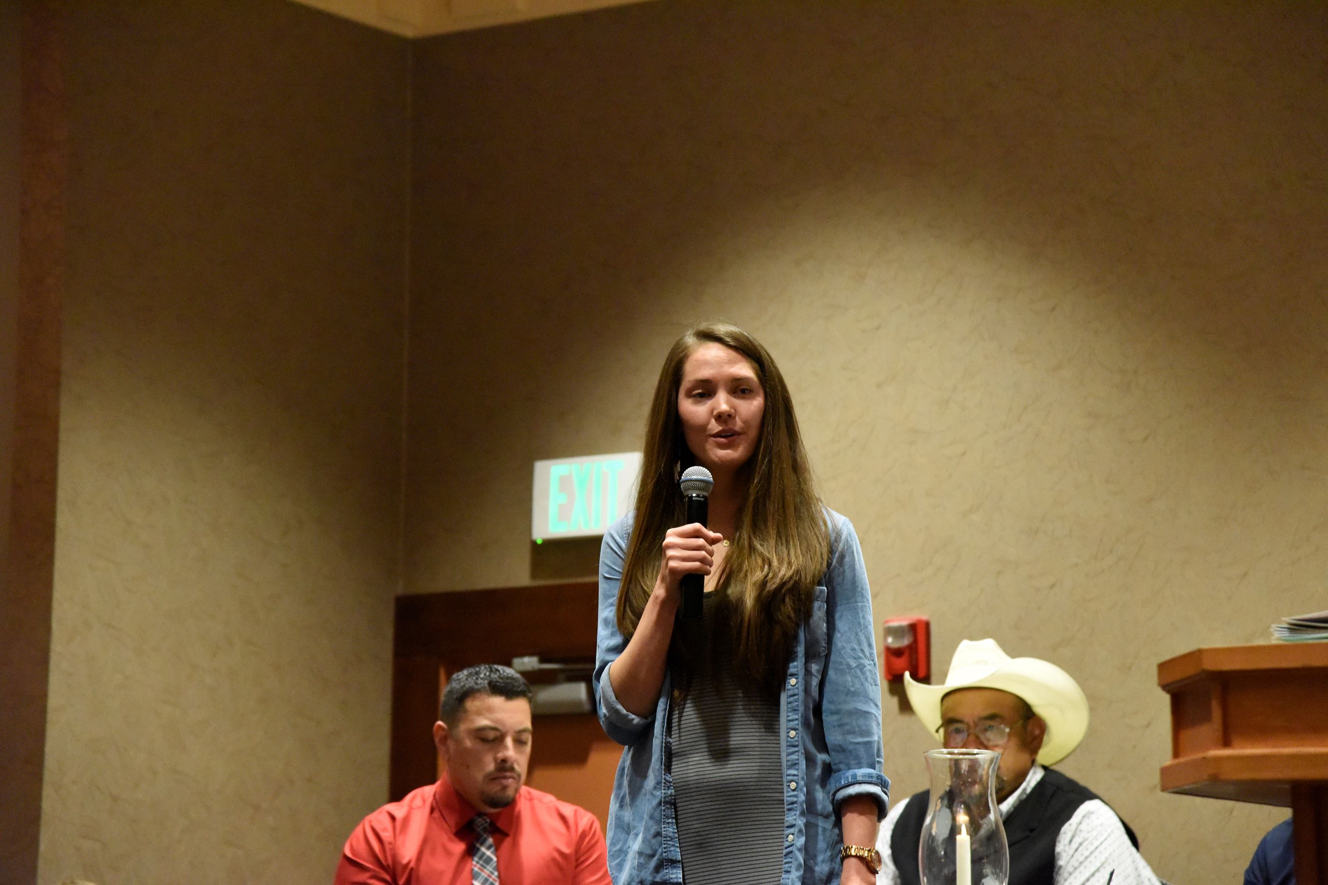 A woman speaking into a microphone