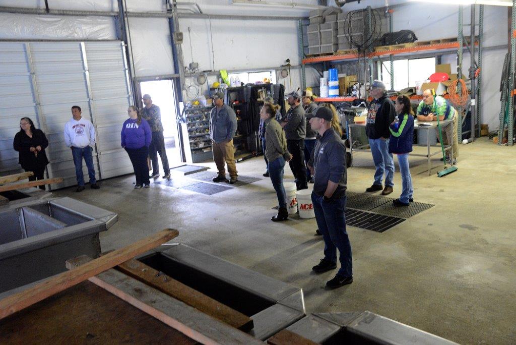 People standing around watching a demo