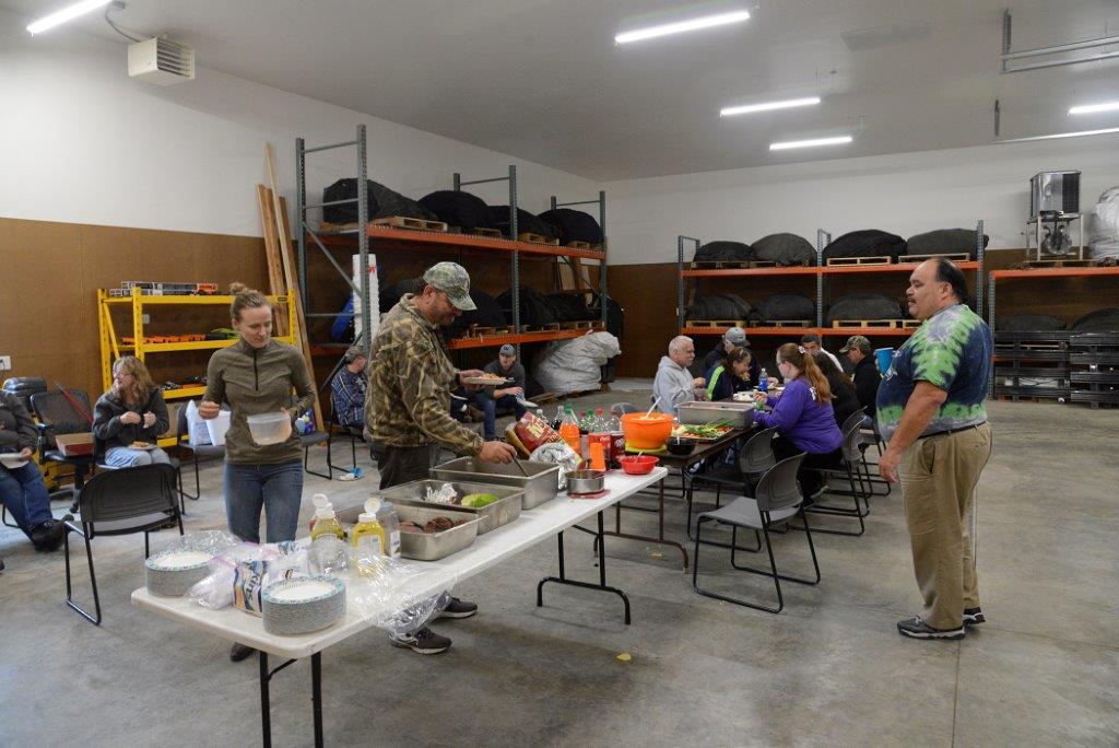 People getting food from a potluck buffet