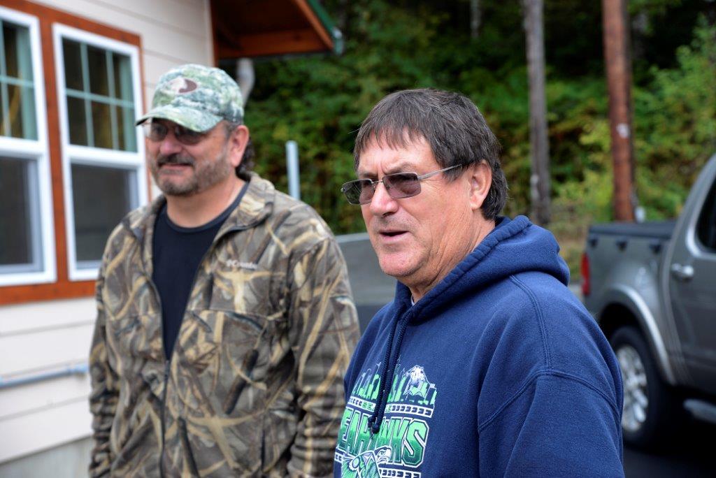Two men standing outside