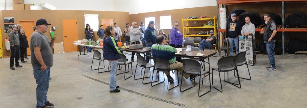 A group of people in a room with tables and chairs